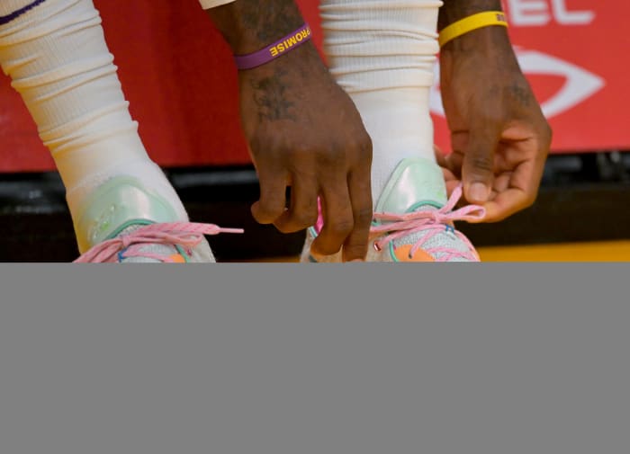 LeBron James tying his Nike shoes.